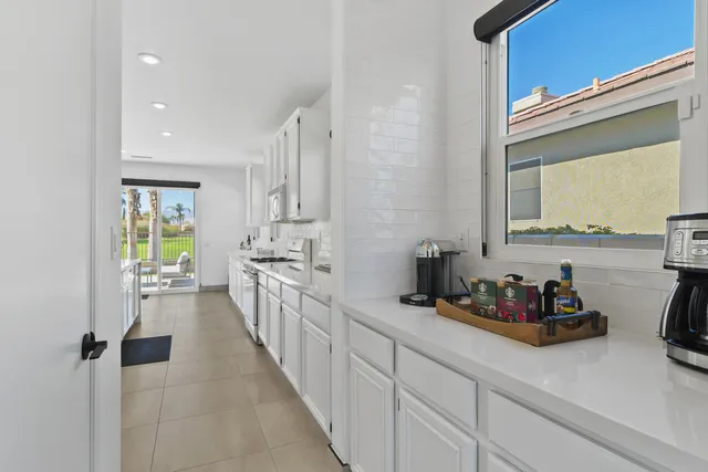 a kitchen with sink cabinets and window