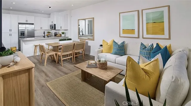 a living room with furniture and painting on the wall with wooden floor