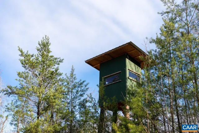 a backyard of a house with a yard and outdoor seating