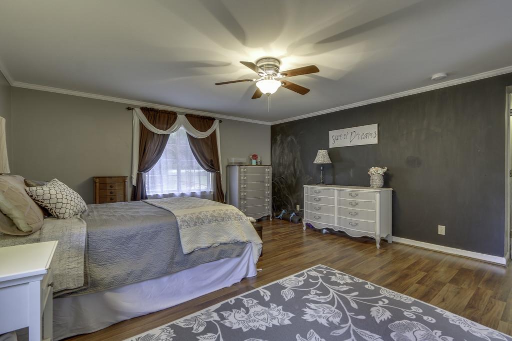 301 Whitson Road Bethpage, TN 37022 - Photo 18 of 29 a bedroom with a bed and wooden floor