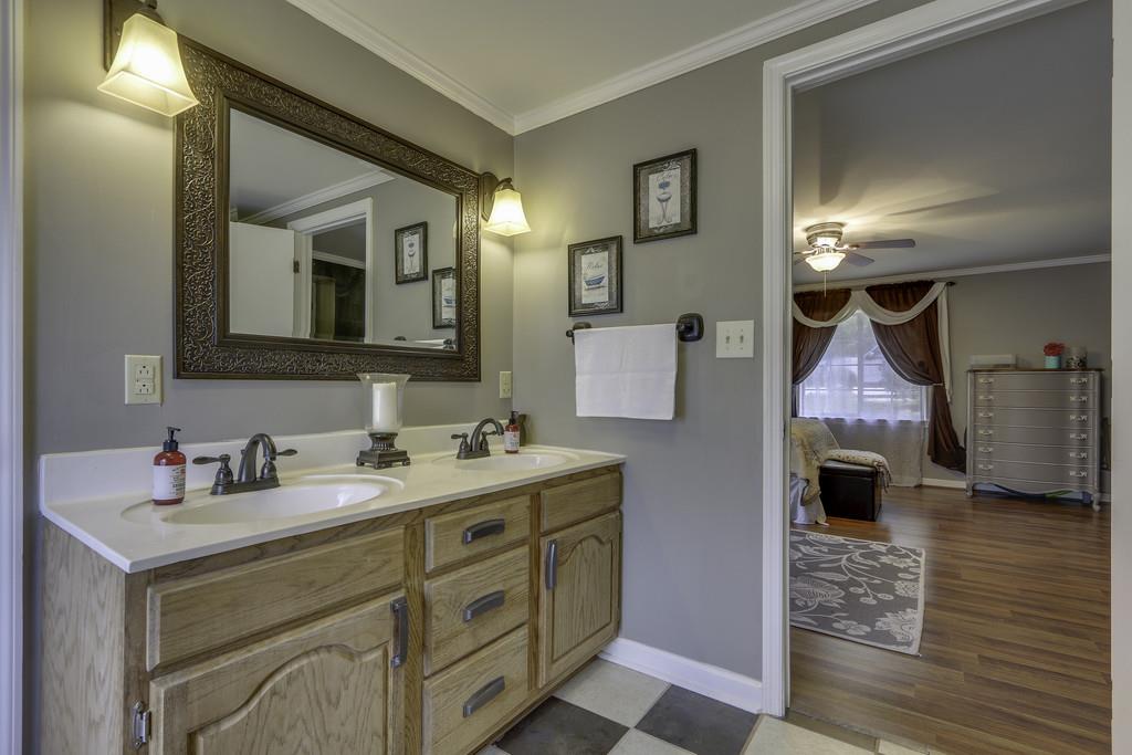 301 Whitson Road Bethpage, TN 37022 - Photo 20 of 29 a bathroom with a double vanity sink mirror and bathtub
