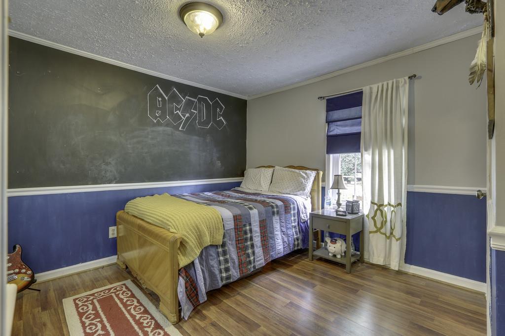 301 Whitson Road Bethpage, TN 37022 - Photo 22 of 29 a bedroom with a bed and wooden floor