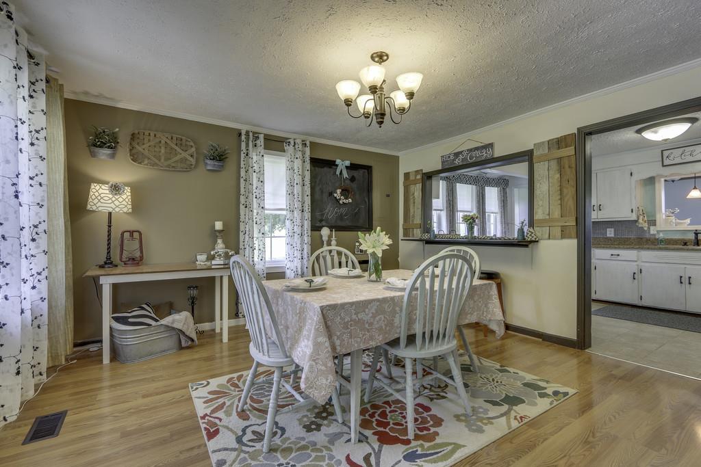301 Whitson Road Bethpage, TN 37022 - Photo 9 of 29 a view of a dining room with furniture a chandelier and wooden floor