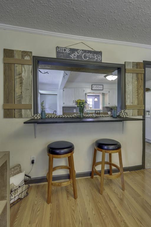 301 Whitson Road Bethpage, TN 37022 - Photo 10 of 29 a hallway with a dining table chairs and a refrigerator