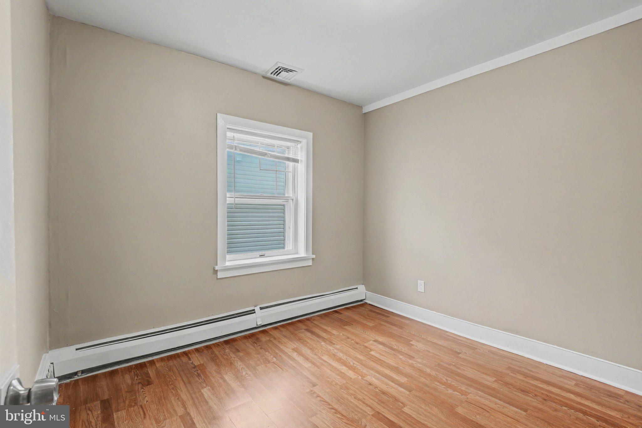808 Locust Street Lebanon, PA 17042 - Photo 17 of 33 a view of an empty room with wooden floor and a window