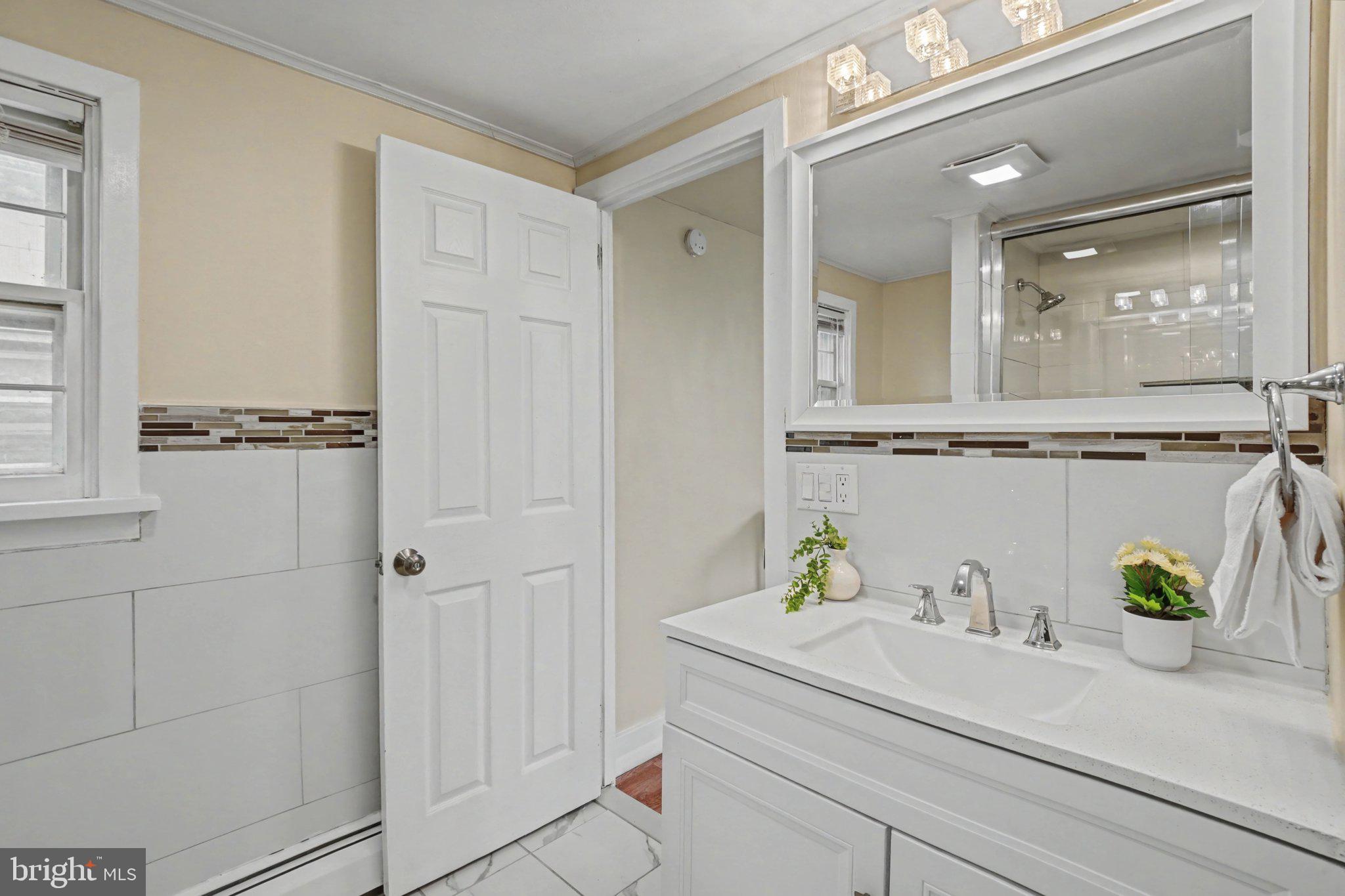 808 Locust Street Lebanon, PA 17042 - Photo 24 of 33 a bathroom with a sink a mirror and a shower