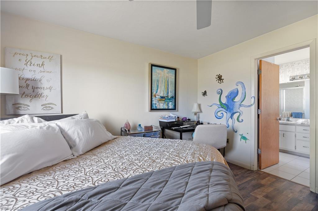 17600 Laurel Valley Road Fort Myers, FL 33967 - Photo 16 of 26 a bedroom with a large bed and a chandelier