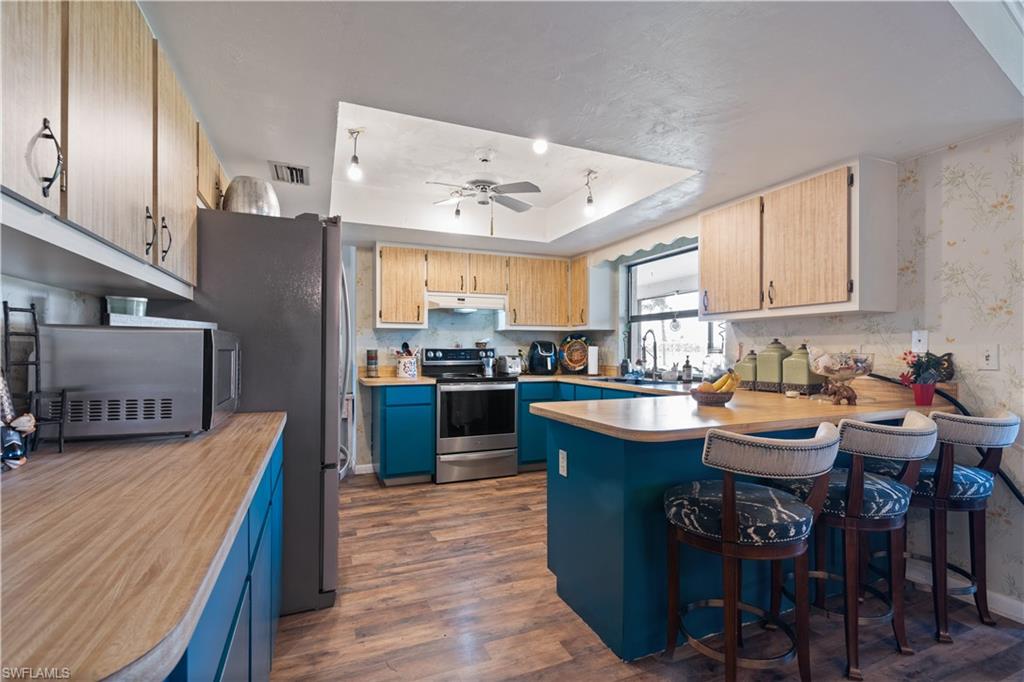 17600 Laurel Valley Road Fort Myers, FL 33967 - Photo 8 of 26 a kitchen with a sink a counter top space and appliances