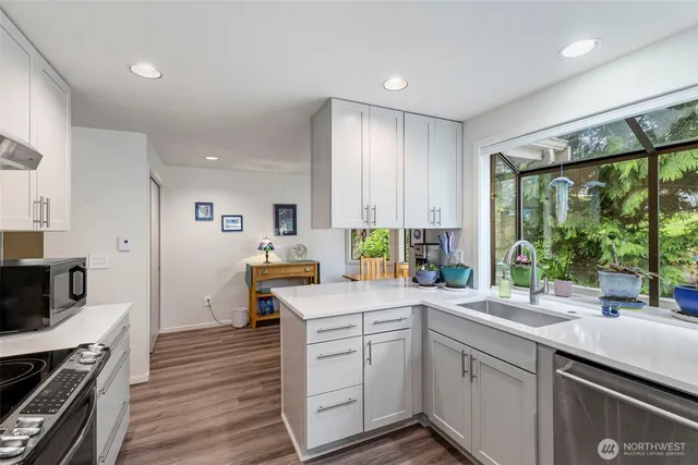 a kitchen with a sink stove and cabinets