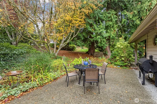 a view of a backyard with furniture and a garden