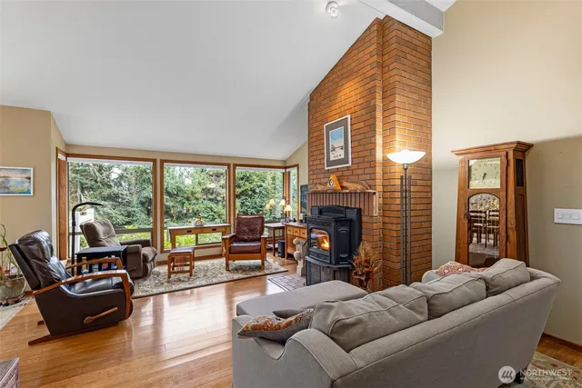 a living room with furniture a fireplace and a floor to ceiling window