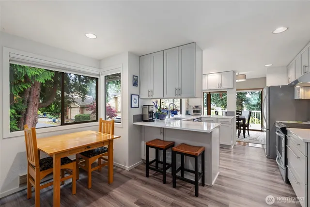 a dining area with furniture window and wooden floor
