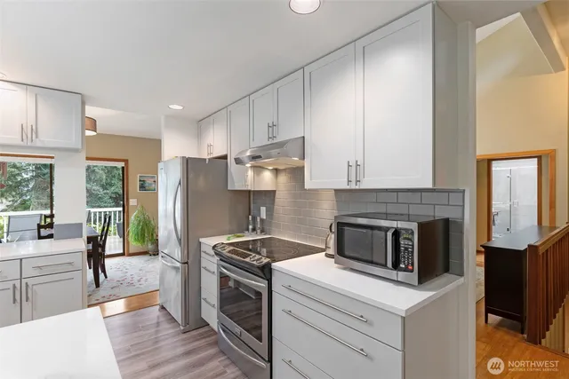 a kitchen with a stove a refrigerator and a sink