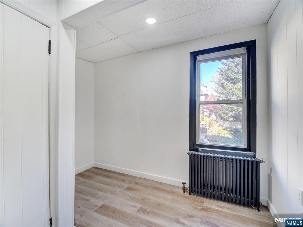 176 Teaneck Road Ridgefield Park, NJ 07660 - Photo 4 of 12 a view of a hallway with wooden floor and a window