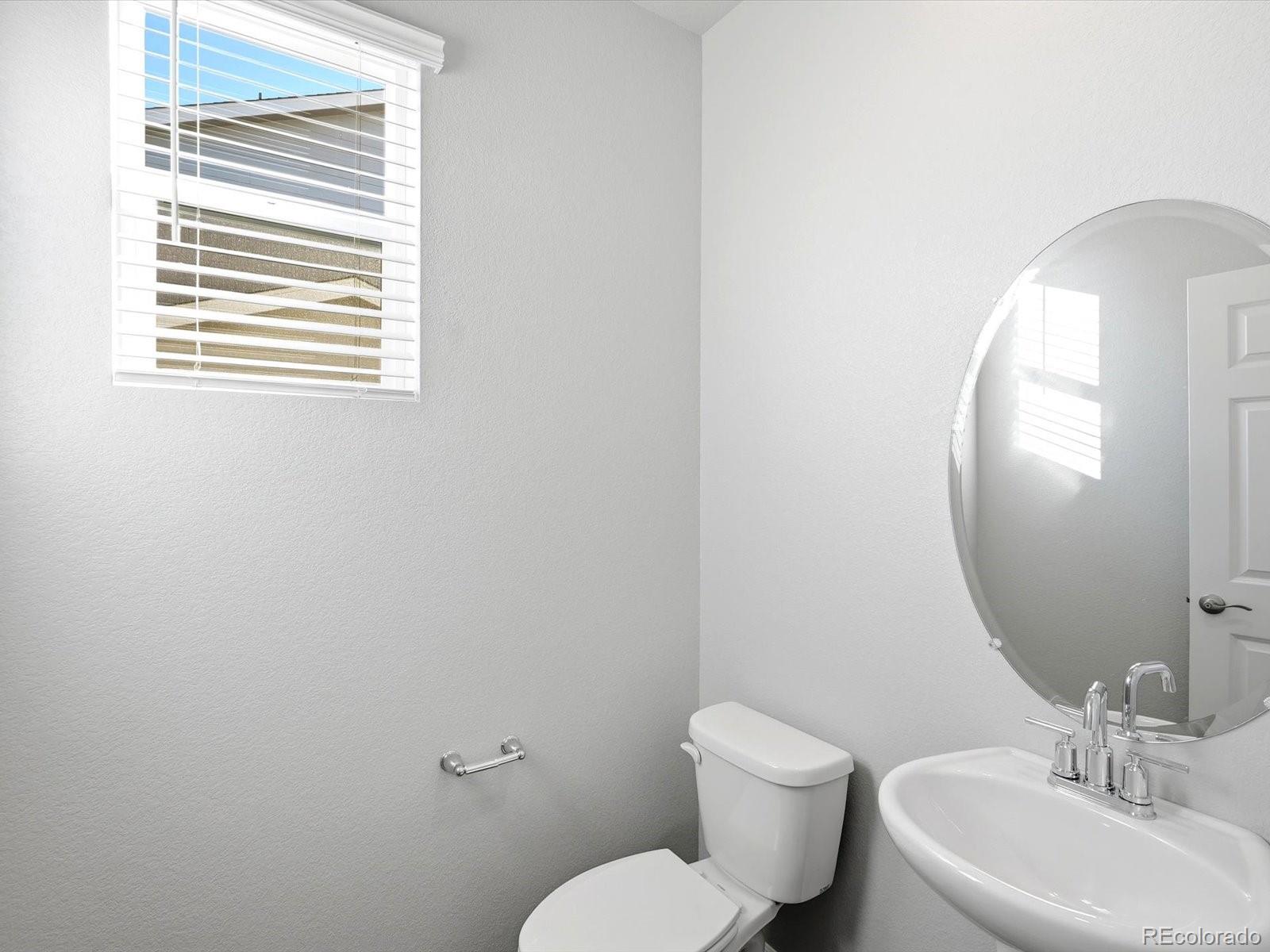 7317 West 27th St Road Greeley, CO 80634 - Photo 4 of 28 a bathroom with a toilet sink and mirror