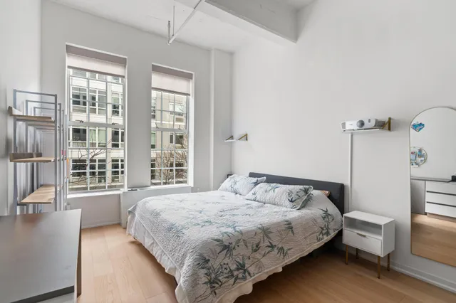 a living room with furniture a flat screen tv and kitchen view