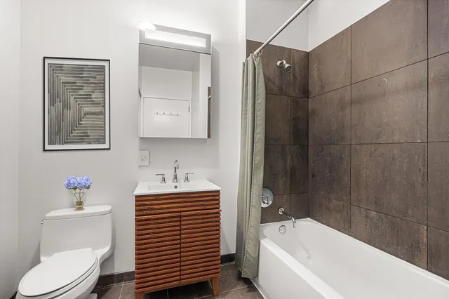 a bedroom with a bed and a lamp