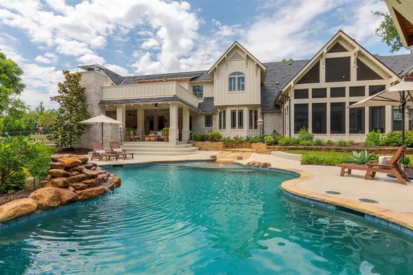 a front view of a house with swimming pool and porch