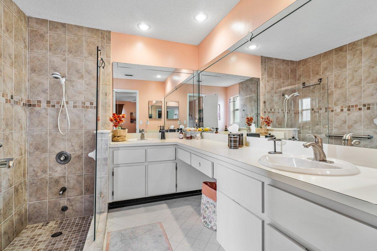 9155 Pine Springs Drive Boca Raton, FL 33428 - Photo 17 of 24 a bathroom with a double vanity sink mirror and shower