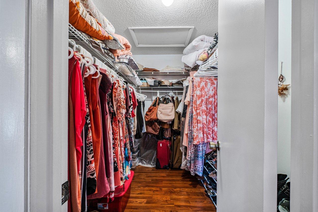 9155 Pine Springs Drive Boca Raton, FL 33428 - Photo 19 of 24 a view of walk in closet with clothes