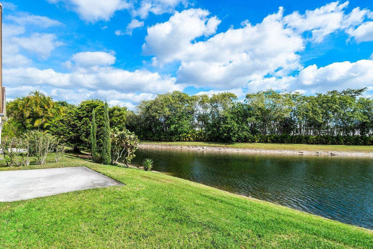9155 Pine Springs Drive Boca Raton, FL 33428 - Photo 23 of 24 a view of a lake from a yard
