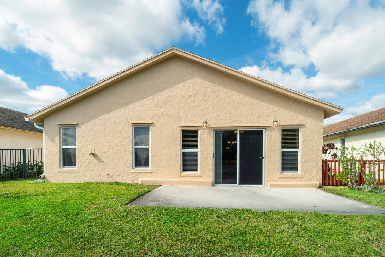 9155 Pine Springs Drive Boca Raton, FL 33428 - Photo 24 of 24 a view of a house with yard