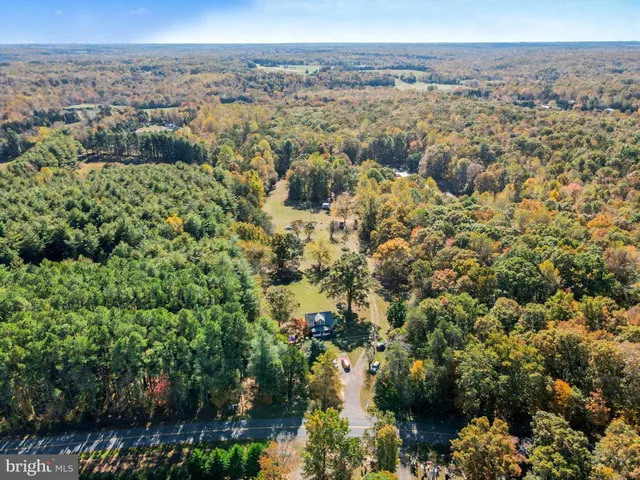 an aerial view of a houses with a yard