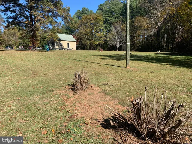 a view of outdoor space with deck and yard