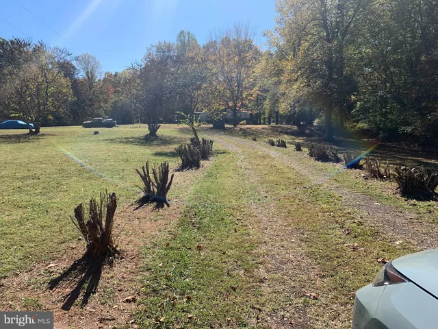 a view of swimming pool with lawn chairs and wooden fence