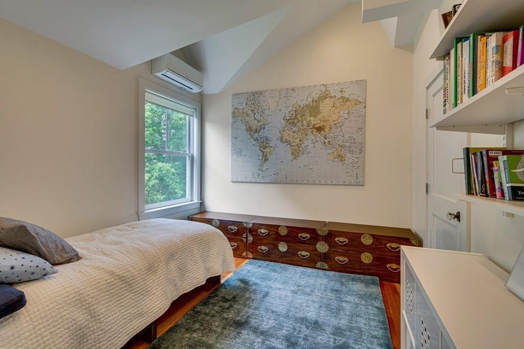 208 Ridge Street Winchester, MA 01890 - Photo 27 of 42 a bedroom with a bed and a book shelf