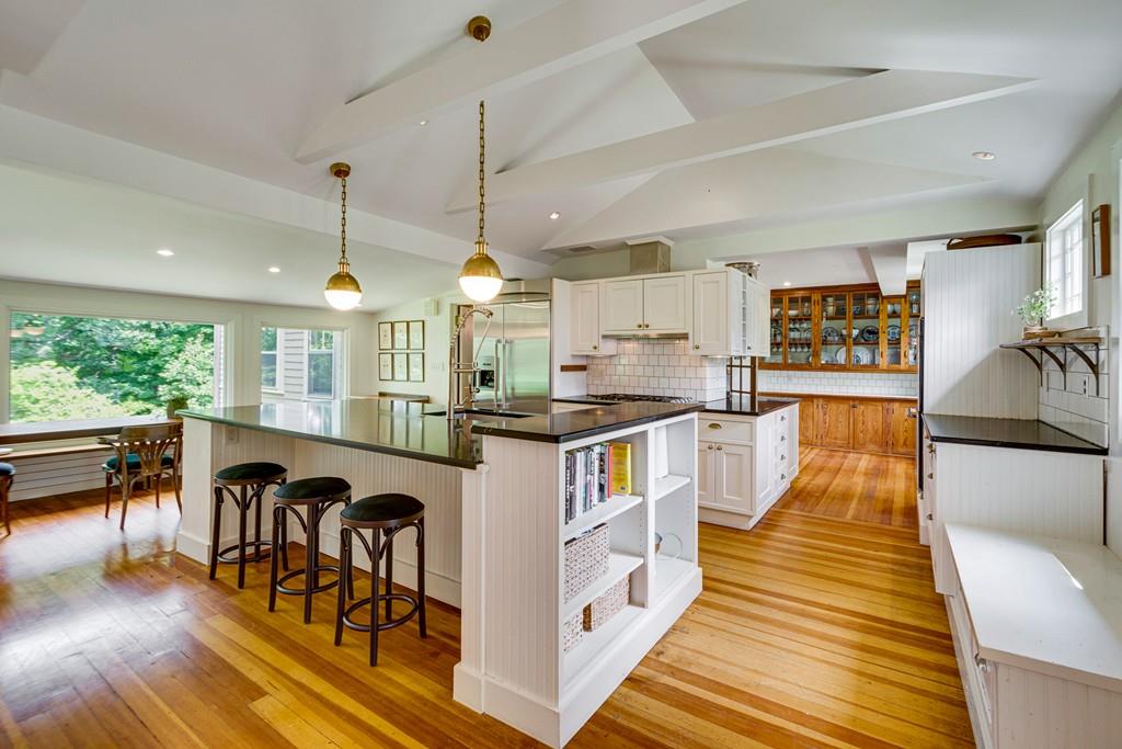 208 Ridge Street Winchester, MA 01890 - Photo 5 of 42 a kitchen with stainless steel appliances granite countertop a stove and a dining table with the living room