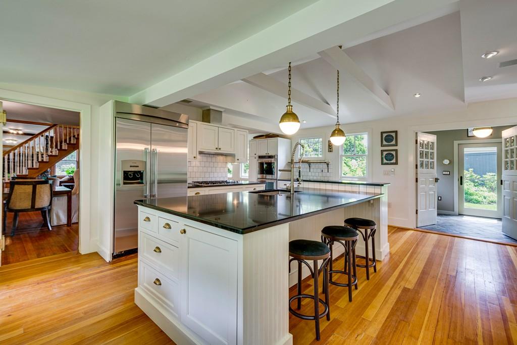 208 Ridge Street Winchester, MA 01890 - Photo 6 of 42 a kitchen with stainless steel appliances granite countertop a sink a stove and a wooden floors