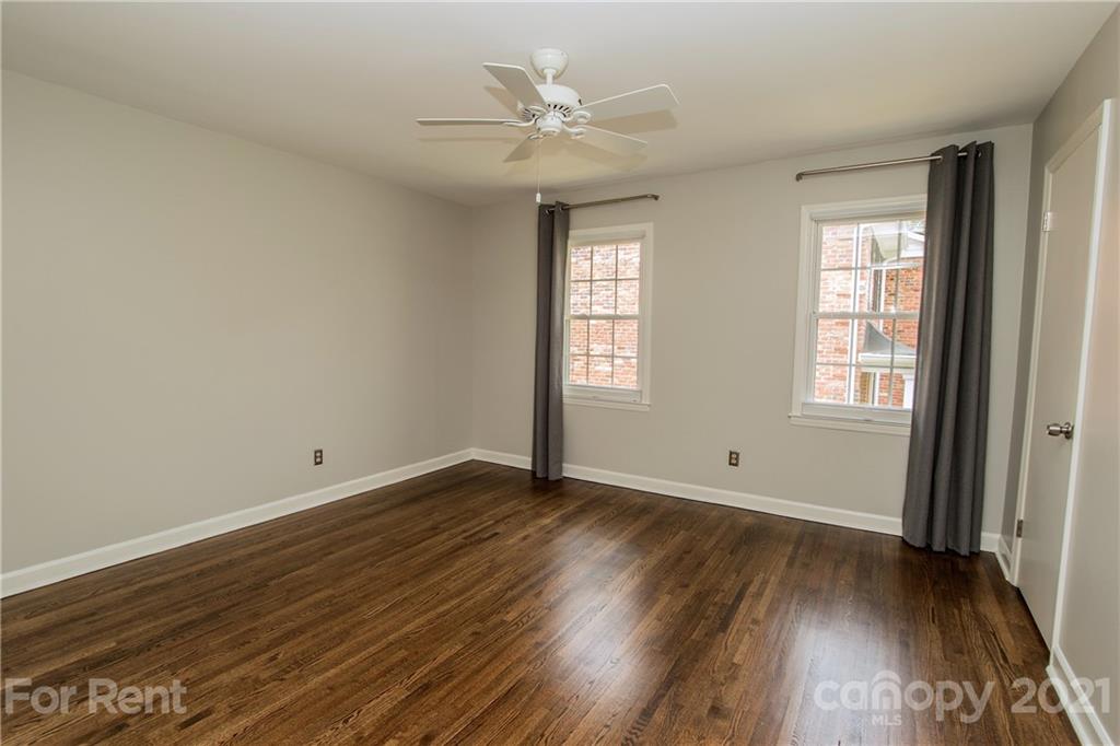 852 McAlway Road Charlotte, NC 28211 - Photo 15 of 26 an empty room with wooden floor and window