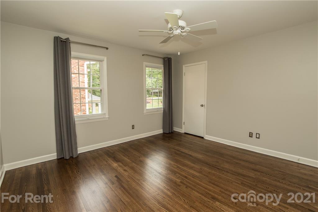 852 McAlway Road Charlotte, NC 28211 - Photo 16 of 26 an empty room with wooden floor and window