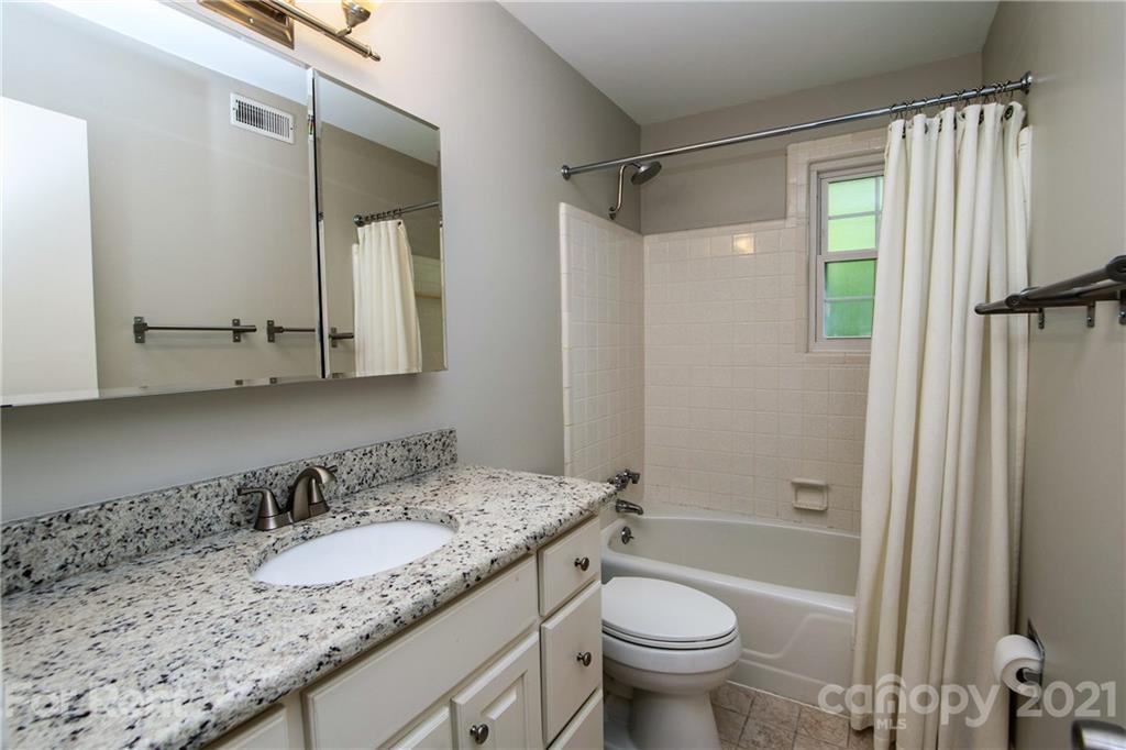 852 McAlway Road Charlotte, NC 28211 - Photo 18 of 26 a bathroom with a granite countertop sink toilet and shower