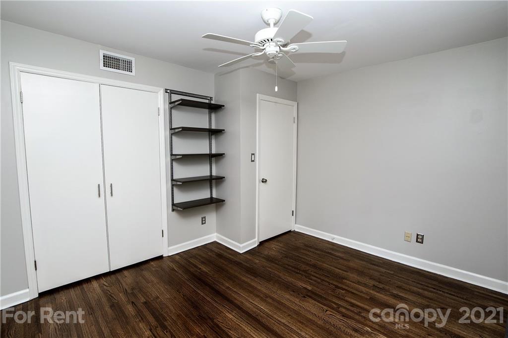 852 McAlway Road Charlotte, NC 28211 - Photo 20 of 26 a view of empty room with wooden floor and fan