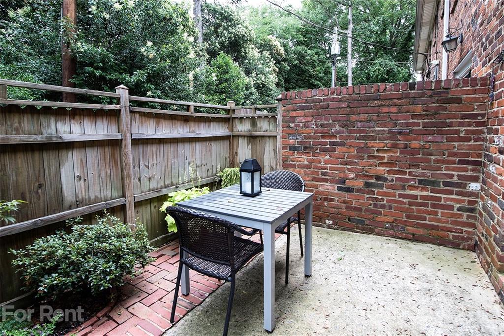 852 McAlway Road Charlotte, NC 28211 - Photo 23 of 26 a backyard of a house with table and chairs
