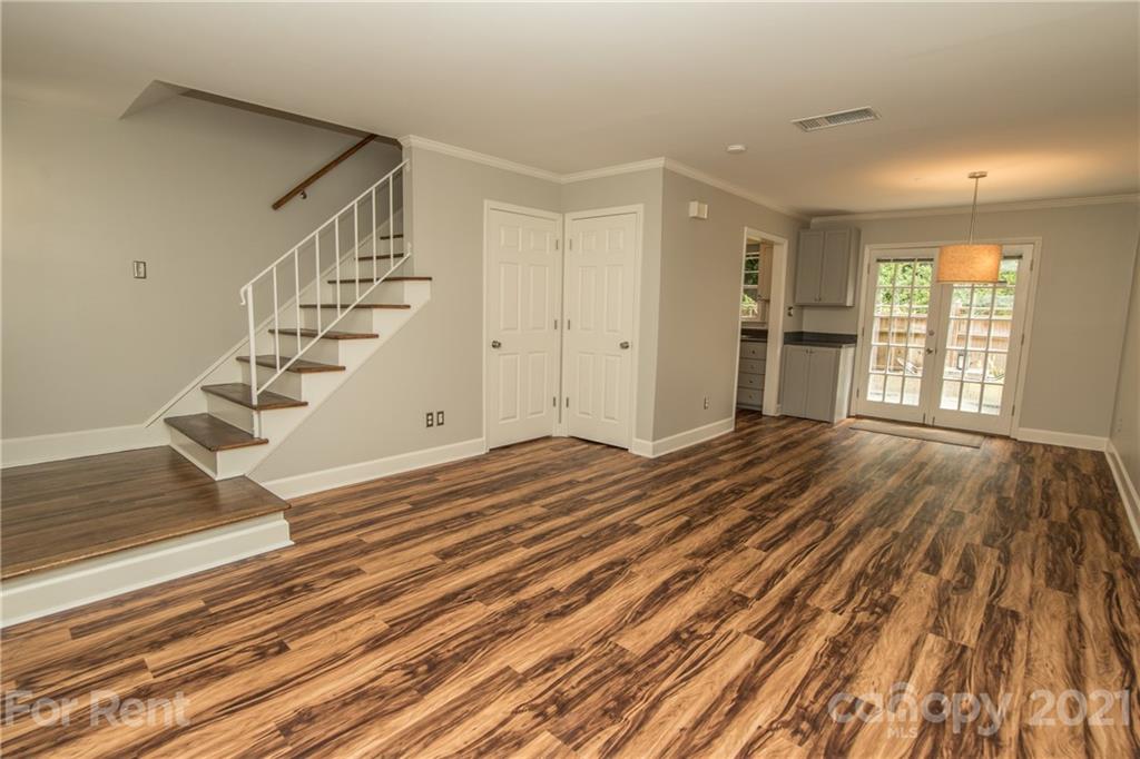 852 McAlway Road Charlotte, NC 28211 - Photo 4 of 26 a view of an empty room with wooden floor and a window