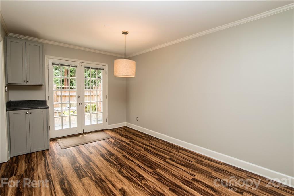852 McAlway Road Charlotte, NC 28211 - Photo 6 of 26 a view of an empty room with wooden floor and a window