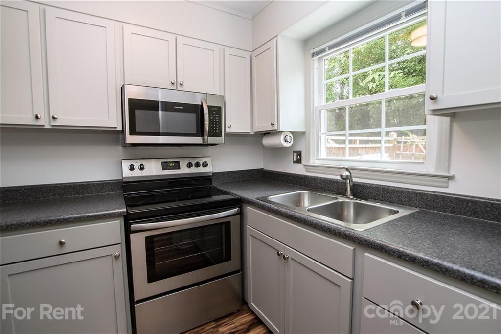 852 McAlway Road Charlotte, NC 28211 - Photo 9 of 26 a kitchen with granite countertop a sink stove and microwave