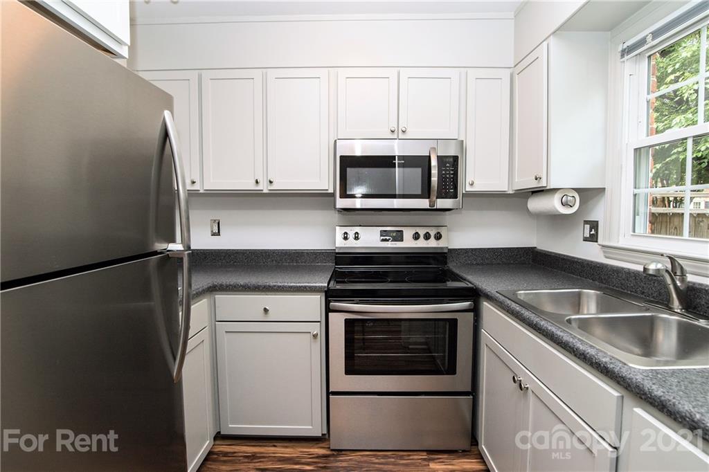 852 McAlway Road Charlotte, NC 28211 - Photo 10 of 26 a kitchen with granite countertop a sink stove and microwave