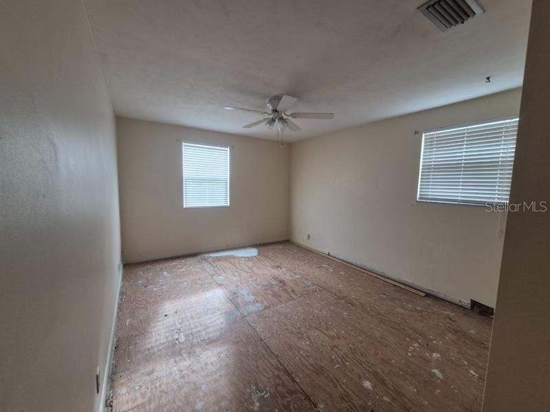1702 Ketch Place Brandon, FL 33511 - Photo 8 of 14 an empty room with windows and fan