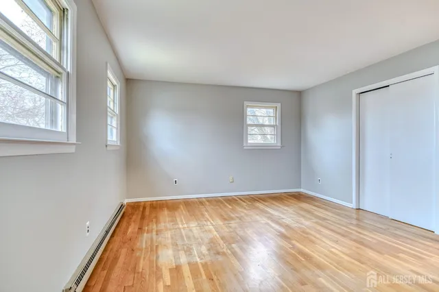 a view of a room with wooden floor and window