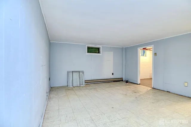 an empty room with a window and closet