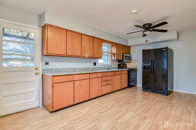 a kitchen with stainless steel appliances granite countertop a refrigerator a sink and dishwasher