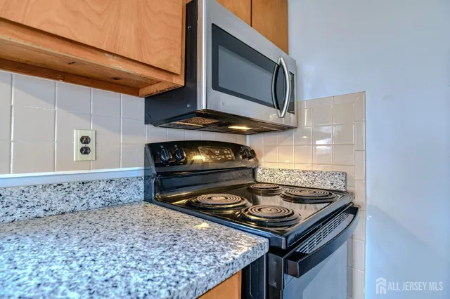 a stove top oven sitting inside of a kitchen