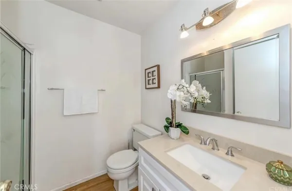 a bathroom with a sink toilet and a mirror