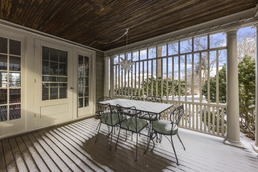 39 Somerset Road Lexington, MA 02420 - Photo 18 of 20 a view of a patio with table and chairs with wooden floor and fence