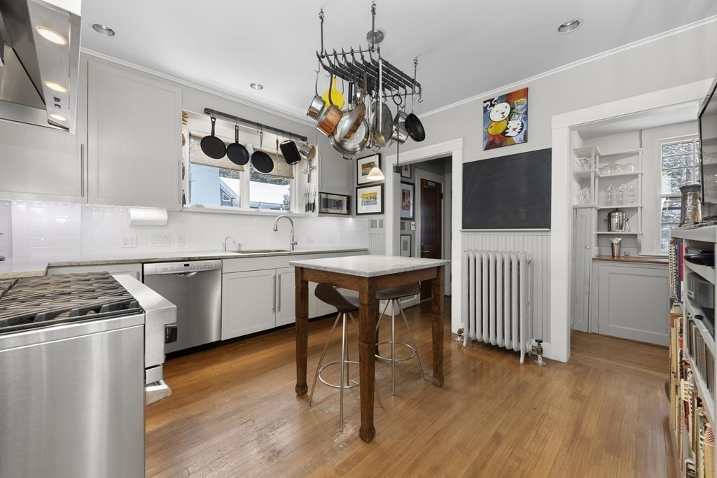 39 Somerset Road Lexington, MA 02420 - Photo 8 of 20 a kitchen with stainless steel appliances granite countertop a sink a stove a microwave a refrigerator cabinets and wooden floor