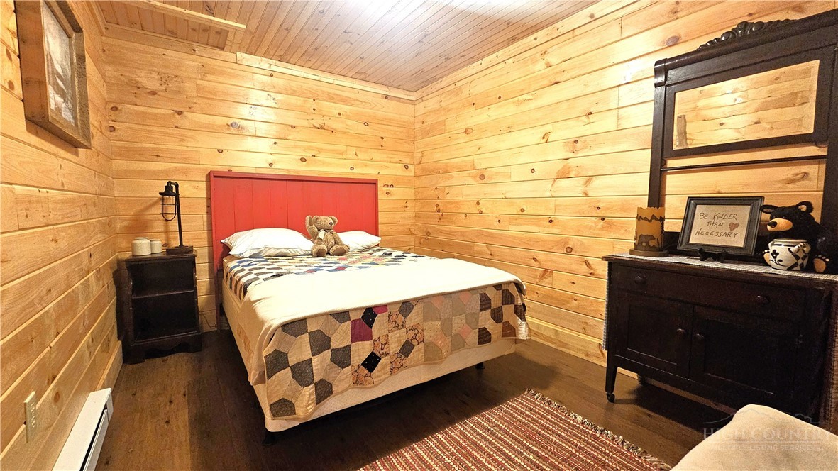 3043 Junaluska Road Boone, NC 28607 - Photo 34 of 49 a bed sitting in a bedroom next to a window